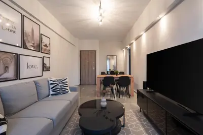 a living room with a couch and a flat screen tv at Relaxing Voula Hideaway in Athens