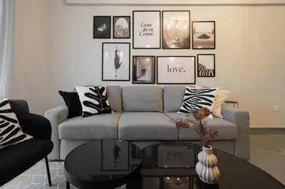 a living room with a couch and pictures on the wall at Relaxing Voula Hideaway in Athens
