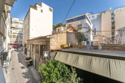 an empty street in a city with buildings at Acropolis Industrial Loft in Athens