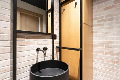 a bathroom with a black tub in front of a door at Acropolis Industrial Loft in Athens