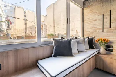 a bench in a window with pillows on it at Acropolis Industrial Loft in Athens