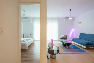 a living room with a blue couch and a blue couch at Zen Bright, Exarchia in Athens