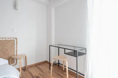a bedroom with a glass table and two stools at Zen Bright, Exarchia in Athens