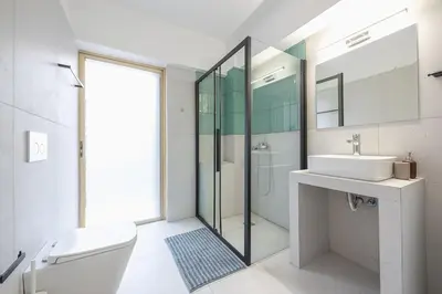 a bathroom with a toilet and a sink and a shower at Zen Bright, Exarchia in Athens