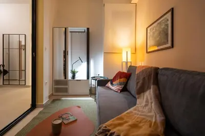 a living room with a couch and a table at Retro-Modern Echoes in Athens