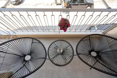 two large metalwheels on a balcony with a plant at Retro-Modern Echoes in Athens