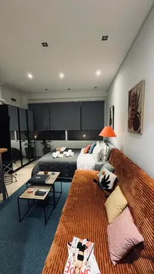 a living room with a couch and a bed at Central Stay in Athens in Athens