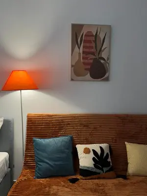 a room with a couch with a lamp and a picture at Central Stay in Athens in Athens