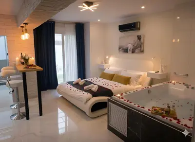 a bedroom with a large bed and a tub at Bubble & Relax- Private Jacuzzi Near Acropolis- Fix Metro 180m in Athens
