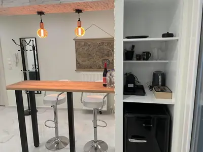 a kitchen with a table and stools in a room at Bubble & Relax- Private Jacuzzi Near Acropolis- Fix Metro 180m in Athens
