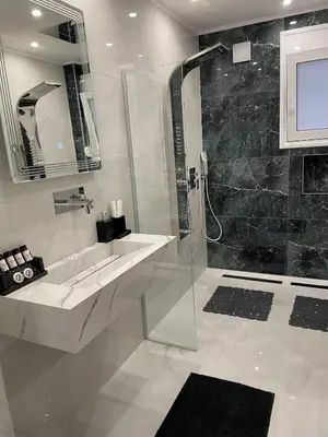 a white bathroom with a shower and a sink at Bubble & Relax- Private Jacuzzi Near Acropolis- Fix Metro 180m in Athens