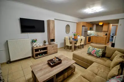 a living room with a couch and a table at Ηappy Apartment 1 in Athens