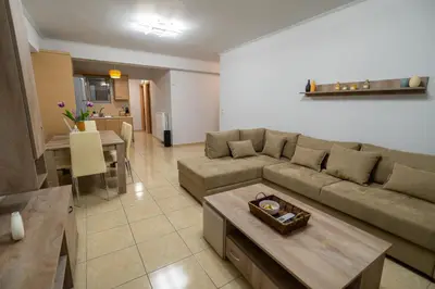 a living room with a couch and a table at Ηappy Apartment 1 in Athens