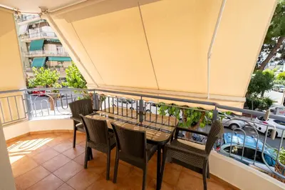 a balcony with a table and chairs on a balcony at Ηappy Apartment 1 in Athens