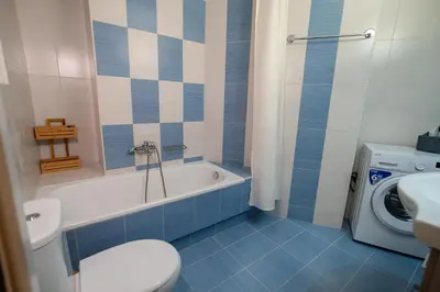 a bathroom with a tub and a toilet and a sink at Ηappy Apartment 1 in Athens
