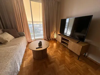 a living room with a large flat screen tv at BFC Glufada in Athens