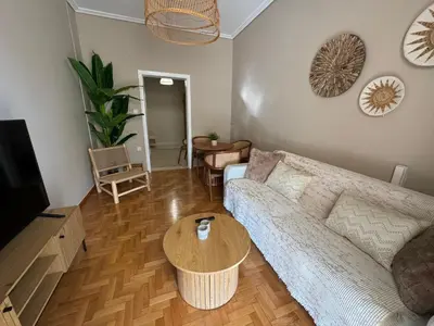 a living room with a couch and a table at BFC Glufada in Athens