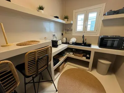a small kitchen with a counter and a microwave at BFC Glufada in Athens