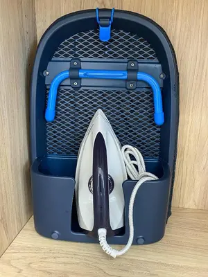 a blue suitcase with a hair dryer in it at Stylish Apartment in the Heart of Athens in Athens