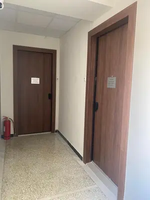 two wooden doors in a room with a hallway at Stylish Apartment in the Heart of Athens in Athens