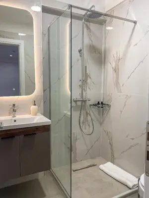 a bathroom with a shower and a sink at Stylish Apartment in the Heart of Athens in Athens
