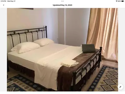 a bedroom with a bed with a laptop on it at Sunshine place in Glyfada in Athens