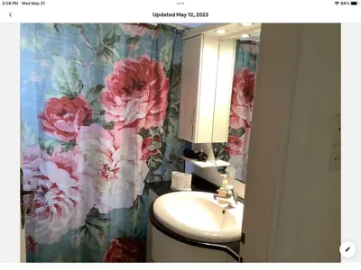 a bathroom with a sink and a flower wallpaper at Sunshine place in Glyfada in Athens