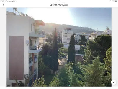 a view of a city with trees and buildings at Sunshine place in Glyfada in Athens