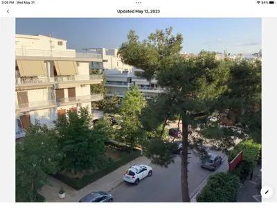 a car parked in a parking lot next to a building at Sunshine place in Glyfada in Athens