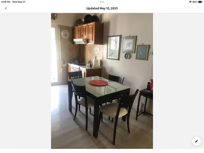 a kitchen and dining room with a table and chairs at Sunshine place in Glyfada in Athens