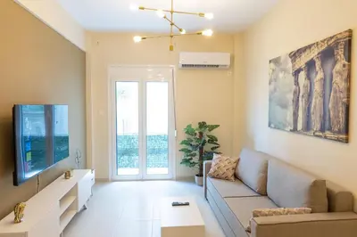 a living room with a couch and a tv at Athens, a modern apartment in the historic center in Athens
