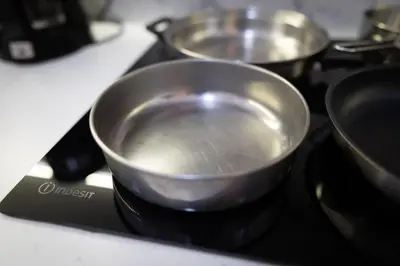 a pan on top of a stove with three pans at Athens, a modern apartment in the historic center in Athens