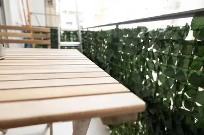 a wooden bench sitting in front of a green wall at Athens, a modern apartment in the historic center in Athens