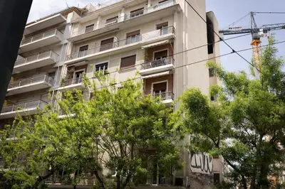 an apartment building with trees in front of it at Athens, a modern apartment in the historic center in Athens