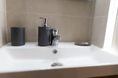 a bathroom sink with a faucet on top of it at Athens, a modern apartment in the historic center in Athens