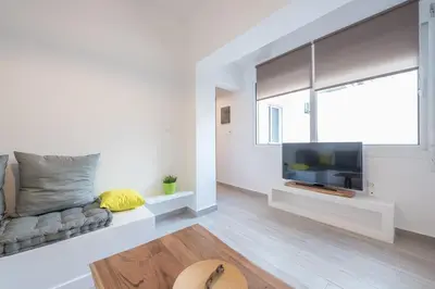 a living room with a couch and a flat screen tv at apartment10minutesfrommonastiraki in Athens