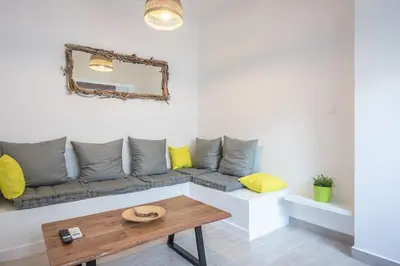 a living room with a couch and a table at apartment10minutesfrommonastiraki in Athens