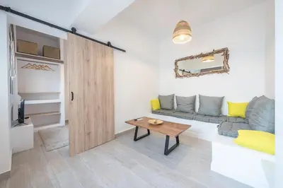 a living room with a couch and a table at apartment10minutesfrommonastiraki in Athens