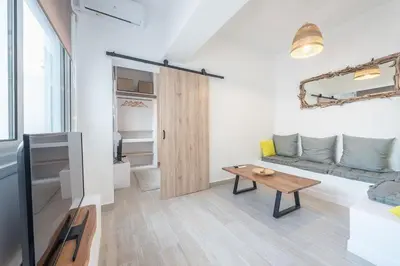 a living room with a couch and a table at apartment10minutesfrommonastiraki in Athens