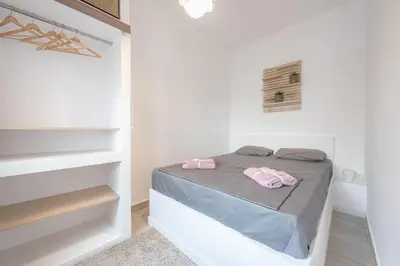 a bedroom with a bed in a white room at apartment10minutesfrommonastiraki in Athens