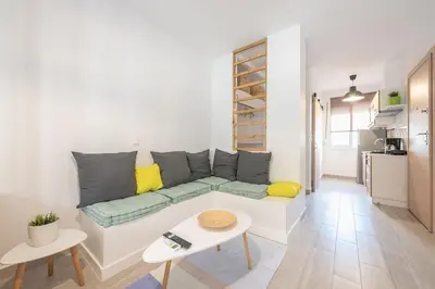 a white living room with a couch and a table at studio 10min from Monastiraki Athens in Athens
