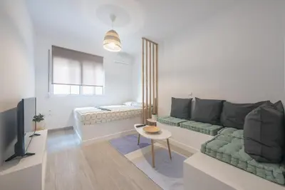 a living room with a couch and a television at studio 10min from Monastiraki Athens in Athens