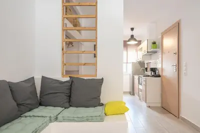a living room with a couch and a kitchen at studio 10min from Monastiraki Athens in Athens