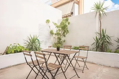 a wooden table and chairs on a patio at studio 10min from Monastiraki Athens in Athens
