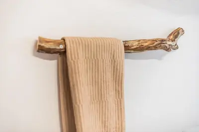 a wooden towel rack with a branch on it at studio 10min from Monastiraki Athens in Athens