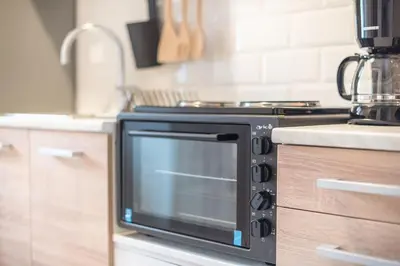 a black oven in a kitchen next to a counter at studio 10min from Monastiraki Athens in Athens
