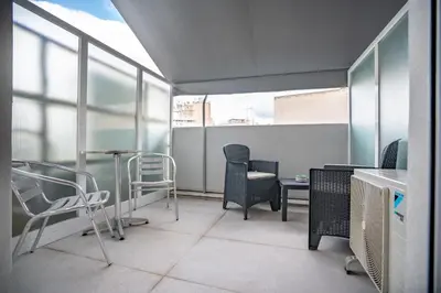a room with chairs and a table and some windows at City Center Studio for 2 by MPS in Athens