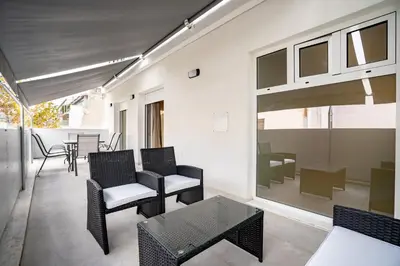 a living room with black chairs and a table at Comfy Studio with private terrace by MPS in Athens