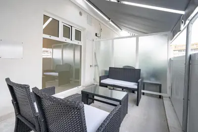 a room with chairs and a table and a couch at Comfy Studio with private terrace by MPS in Athens