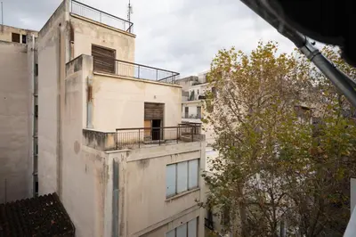 an old building with a balcony on the side of it at Comfy Studio with private terrace by MPS in Athens